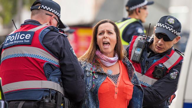 An animal rights protester who had blocked the intersections of Flinders and Swanston St in Melbourne’s CBD is removed by police. Picture: AAP