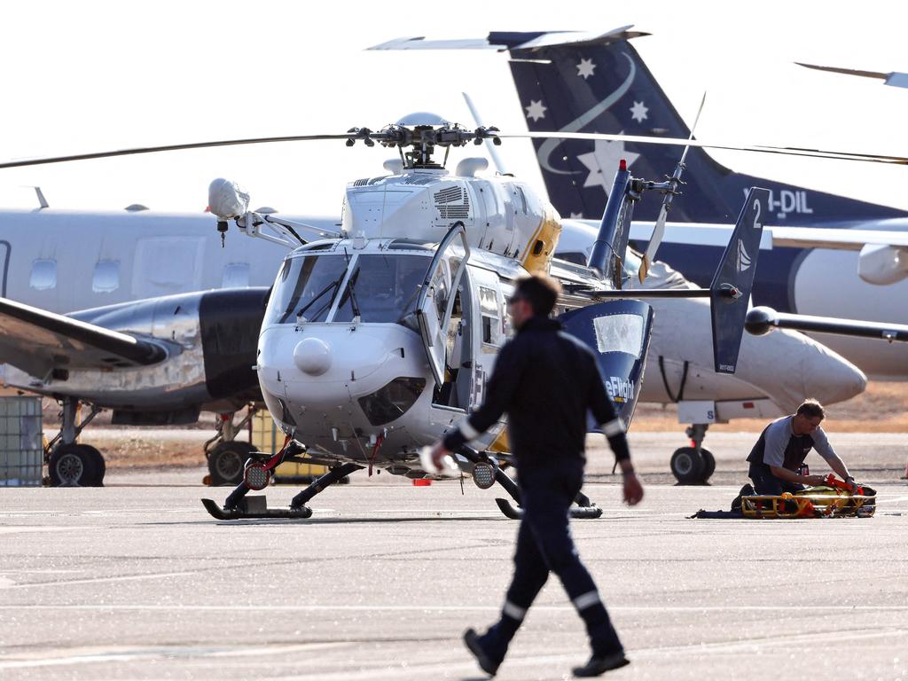 A Care Flight helicopter on the tarmac of the Darwin International Airport during the rescue of those injured in the US Osprey military aircraft crash. Picture: AFP