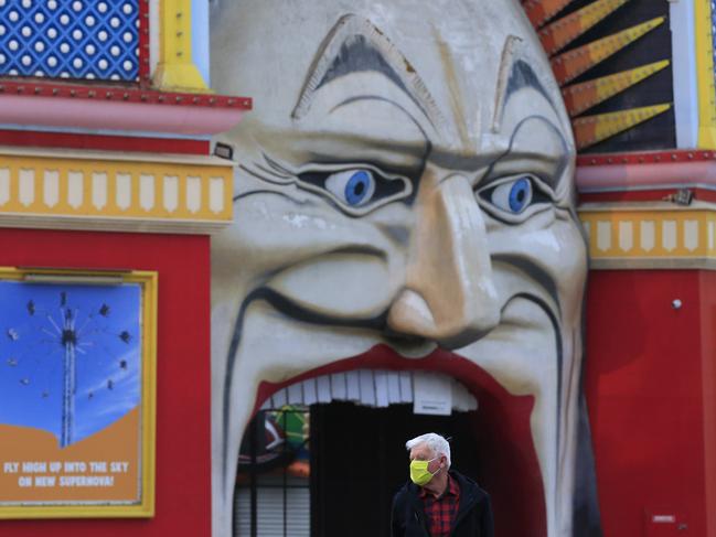 A man catching a tram in St Kilda wears a face mask. Picture: Getty