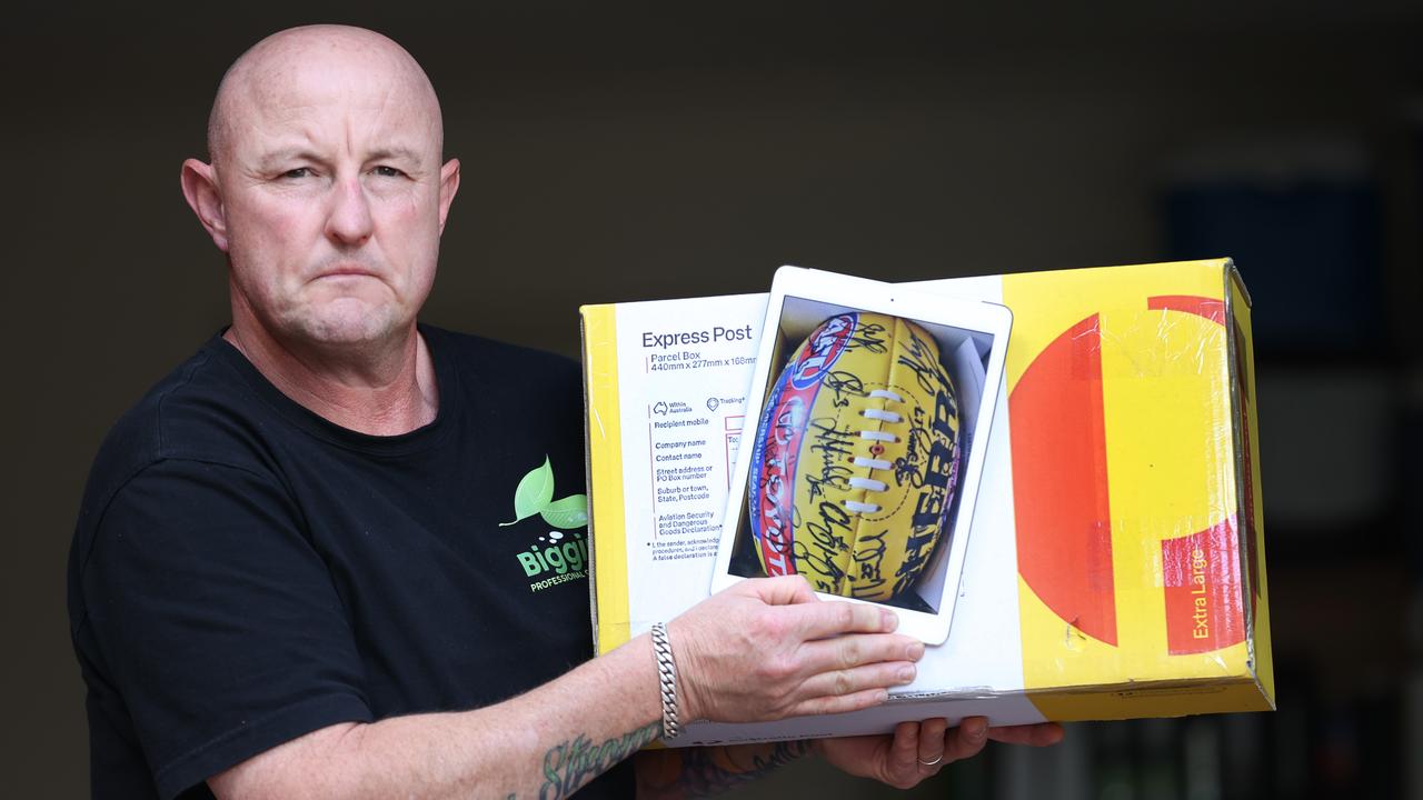 Brent Aitken with a football – signed by Melbourne’s premiership players – bought from Ricky Nixon. Picture: David Caird