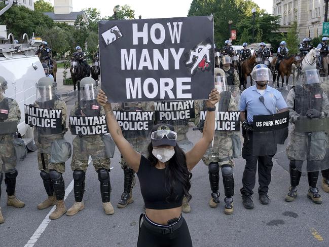 A demonstrator holds up a sign in front of a police line during a protest in downtown Washington, DC. Picture: Getty Images/AFP