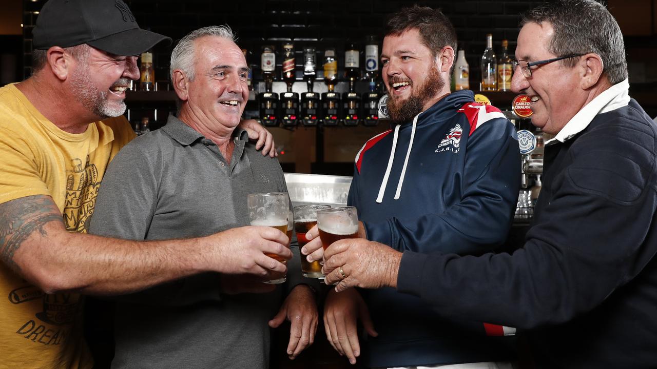 Locals from left Craig Moir, Kevin McMullan, Adam Mules, and Peter Small enjoying a beer at The Plough and Harrow Hotel in Camden. Publican Russ Lowe (behind the bar) has weathered the challenges of COVID-19 and has his sights set on recovery. Picture: Jonathan Ng