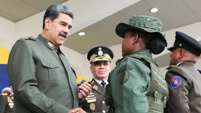 Venezuela's President Nicolas Maduro (L) and Defence Minister Vladimir Padrino (C) attending a militar ceremony. Picture: AFP.