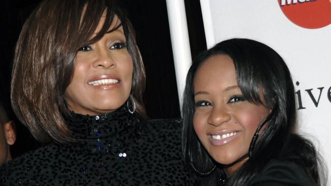 FILE - In this Feb. 12, 2011, file photo, singer Whitney Houston, left, and daughter Bobbi Kristina Brown arrive at an event in Beverly Hills, Calif. Brown is moving to hospice care after months of receiving medical care. Pat Houston says in a statement Wednesday, June 24, 2015, that Whitney Houston’s daughter’s “condition has continued to deteriorate. Brown was found face-down and unresponsive in a bathtub of her Georgia home earlier this year. She underwent surgery to replace her breathing tube with a tracheostomy tube in February. (AP Photo/Dan Steinberg, File)