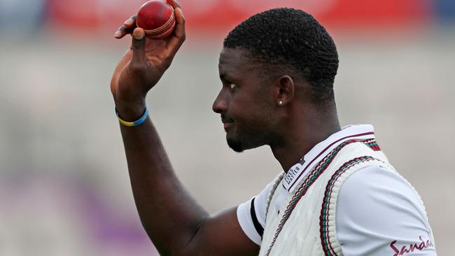 West Indies' Jason Holder leaves the field with the ball after taking six wickets to help bowl out England for 204 runs in the first innings on the second day of the first Test cricket match between England and the West Indies at the Ageas Bowl in Southampton, southwest England on July 9, 2020. (Photo by Adrian DENNIS / POOL / AFP) / RESTRICTED TO EDITORIAL USE. NO ASSOCIATION WITH DIRECT COMPETITOR OF SPONSOR, PARTNER, OR SUPPLIER OF THE ECB