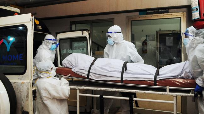 Health workers wearing protective gear shift the body of a person who died of a Nipah virus infection in India's Kerala state. Picture: AFP