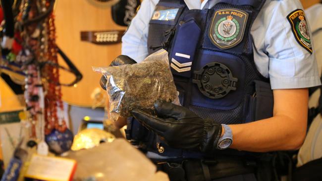 Police seize two kilograms of cannabis after a cafe and bookshop were raided.