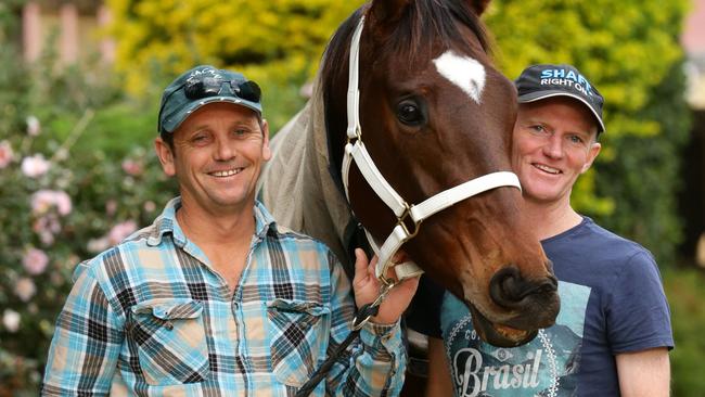 Vaughn Sigley, left, and jockey Glenn Smith with Black Heart Bart. Picture: Darren England.