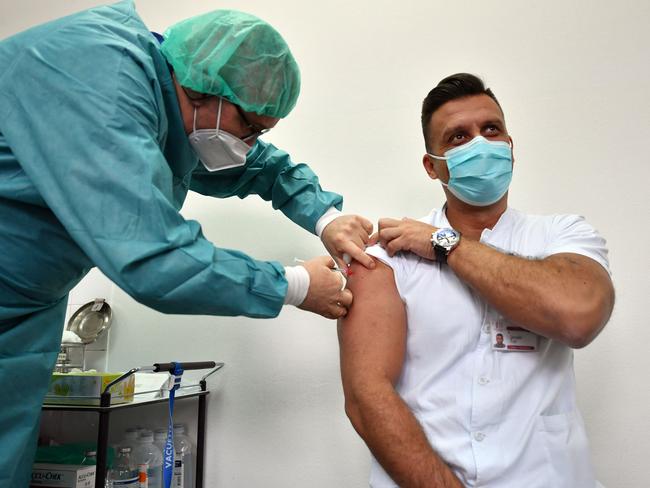 Bosnian medical worker receives his Covishield Covid-19 vaccine, as first round of vaccination begins in Muslim-Croat Federation entity of Bosnia and Herzegovina, at Sarajevo General hospital, in Sarajevo, on March 10, 2021. - Medical workers are first people to receive AstraZeneca/Oxford Covishield vaccines from the batch (10, 000 vaccines) donated by president of neighbouring Serbia, earlier this months. Bosnia's foreign minister voiced anger on March 9, 2021 that her country had yet to receive any of the promised vaccines from the EU-backed Covax scheme, saying Bosnians were "justifiably unhappy". (Photo by ELVIS BARUKCIC / AFP)