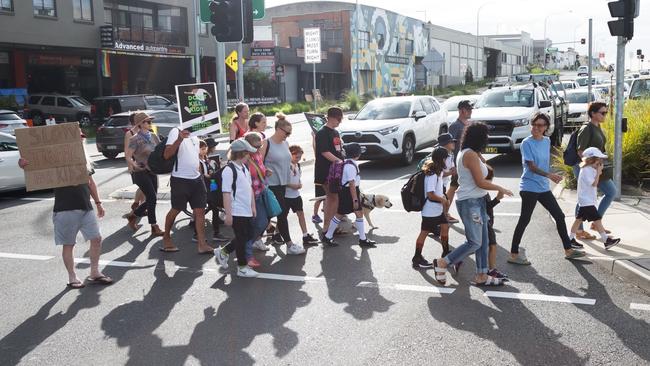 A group of locals protesting the need for a school zone at the Campbell St crossing. Picture: Martin Brady.