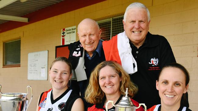 (L-R) Nicole Campbell, Bill Herron, coach Michelle O'Brien, John Hall and Alana Browne, captain, from Christies Beach Football Club which celebrated the win of its first women's football premiership last weekend. Their flag victory came exactly 50 years after the club's men won their first A-Grade flag in 1967, of which Bill, pictured with a vintage guernsey over his shoulder, was captain and coach in Adelaide, Monday, September 11, 2017. (AAP Image/Morgan Sette)