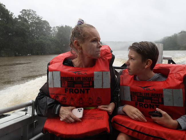 Alicia Pitt and son Travis Pitt are evacuated by a rescue boat after getting trapped by floodwaters on the Hawkesbury River, as the state of New South Wales experiences widespread flooding and severe weather, in western Sydney. Picture: Reuters