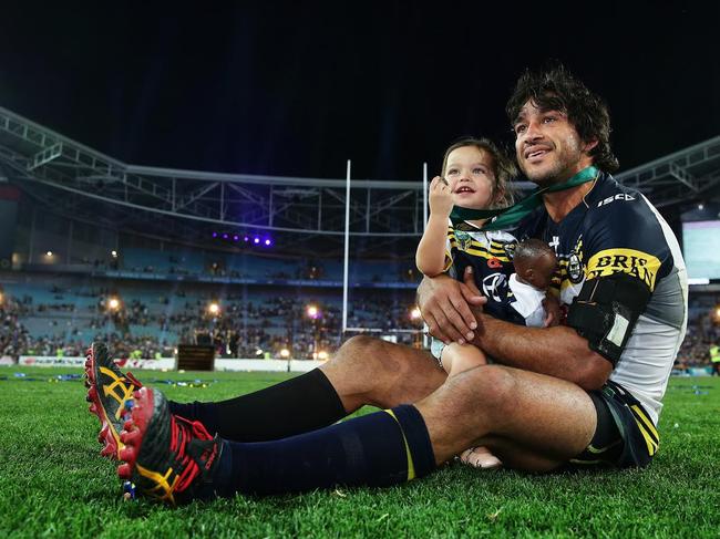 Thurston soaking in the victory with his young daughter Frankie. Picture: Brett Costello