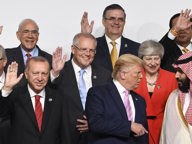 Australian Prime Minister Scott Morrison dutifully waves his hand as the US and Saudi leaders chat to one another. Picture: AAP Image/Lukas Coch.