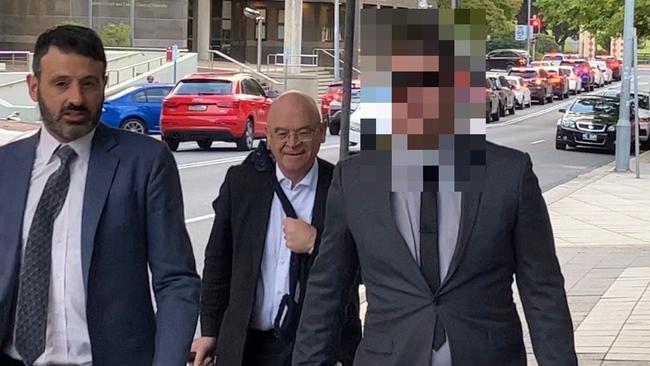 Glenn Robinson (right) leaves Parramatta District Court with his legal representatives after the first day of his trial for an alleged rape in April 2021.