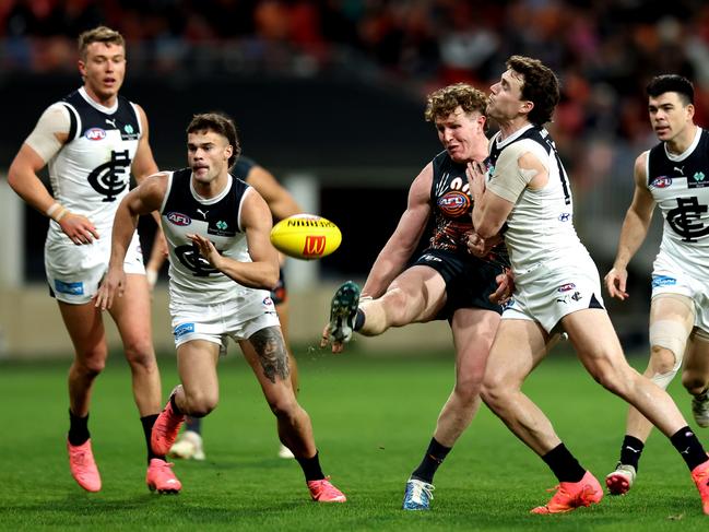 GWS star Tom Green gets a kick away under pressure from Carlton’s Blake Acres. Picture: Brendon Thorne/AFL Photos