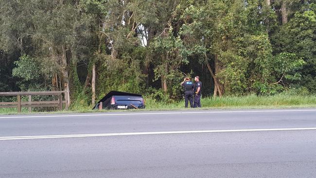 The black Ford ute abandoned in a ditch off McKinnon Drive, Tewantin, after crashing into a pedestrian bridge during suspected hooning. Photo: Paul Garratt.