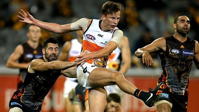 Lachie Whitfield gets a kick away against Hawthorn. Picture: Wayne Ludbey