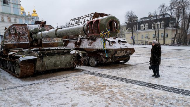 A woman looks at destroyed Russian military vehicles on display in central Kyiv.