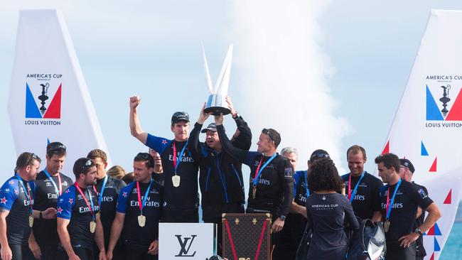 Emirates Team New Zealand helmsman Peter Burling and skipper Glen Ashby celebrate with their team.