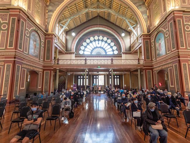 People seen waiting for their Covid-19 vaccine at the mass vaccination centre at Melbourne’s Exhibition Building. Picture: Jason Edwards