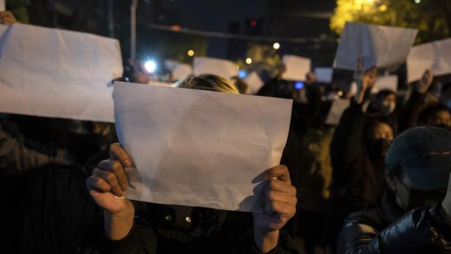 Protesters hold up a white piece of paper against censorship as they march against China’s strict zero Covid measures in Beijing, China. Picture: Kevin Frayer/Getty Images.