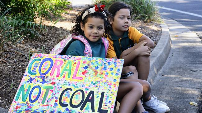 Mayari Holland, 8, and her brother Ilaw Holland join their father and other climate change protesters on the street in front of the regional sitting of Queensland parliament, held at the Cairns Convention Centre. Picture: Brendan Radke