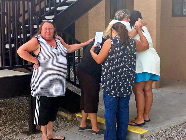 Women mourn near the apartment in Albuquerque where the body of a 10-year-old girl was found. Picture: AP