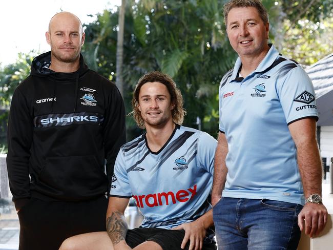 Nicho Hynes, flanked by Cronulla assistant coaches Daniel Holdsworth and Steve Price, at home this week after the trio’s lifesaving heroics. Picture: Richard Dobson