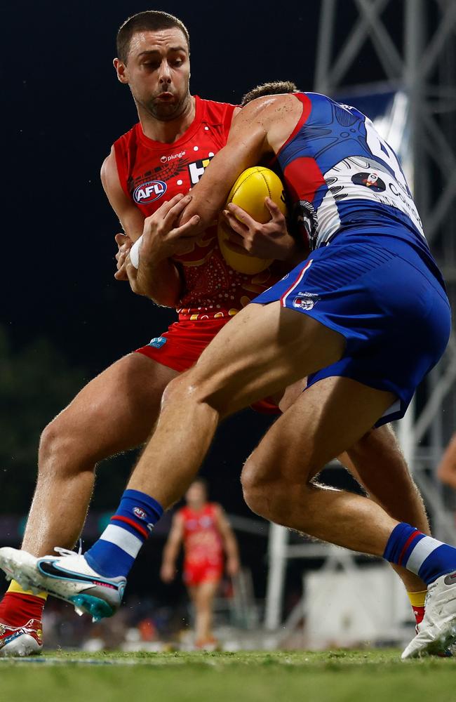 Rory Atkins of the Suns is tackled by Marcus Bontempelli of the Bulldogs during the 2023 AFL Round 11 match between the Gold Coast Suns and the Western Bulldogs at TIO Stadium. (Photo by Michael Willson/AFL Photos via Getty Images)