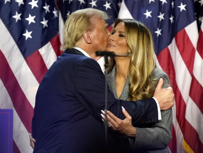 Republican presidential nominee former President Donald Trump, left, kisses Melania Trump at an election night watch party. Picture: AP