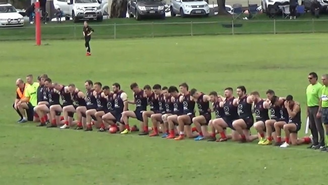 Pooraka Football Club players take a knee during the national anthem before their division five grand final. Picture: Supplied