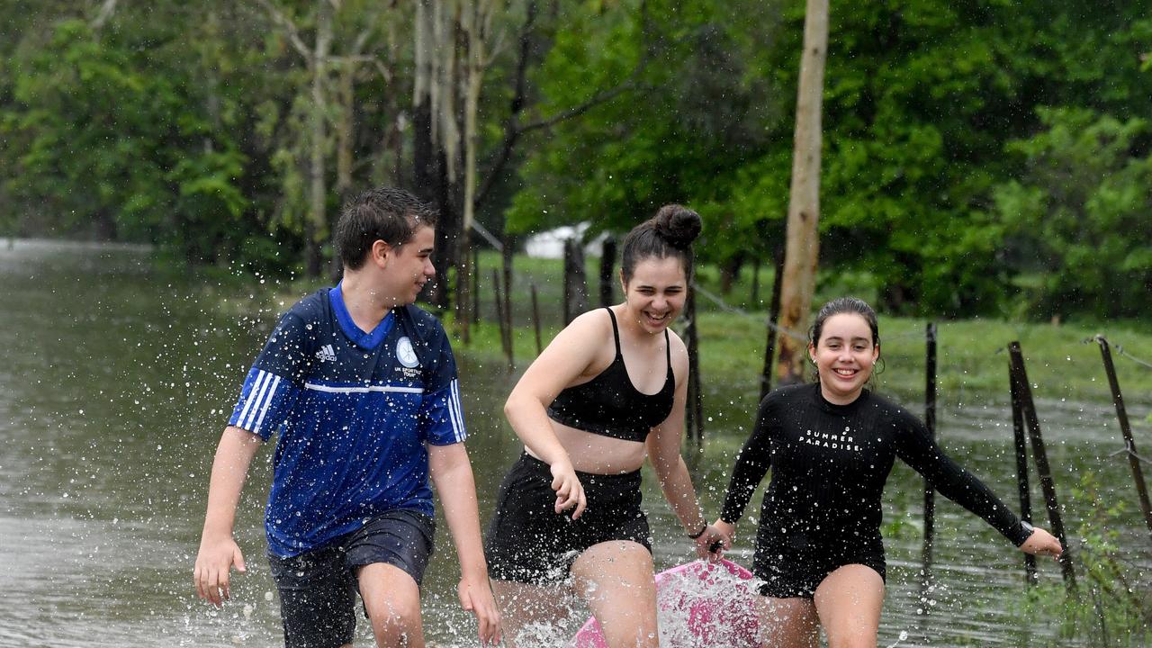 Wet weather in Townsville. Matty, 14, Lexie, 16, and Charlie Wendt, 11, enjoy the rain in Kelso. Picture: Evan Morgan