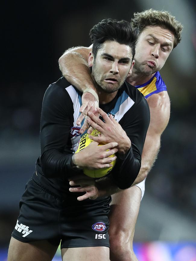 Power’s Chad Wingard under pressure from the Eagles Mark Hutchings. Picture Sarah Reed