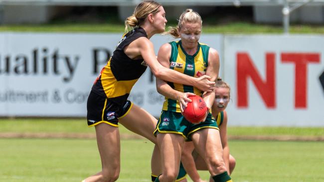 PINT's Cassie Henderson is grabbed by Nightcliff ruck Olivia Hatzismalis in their Round 13 match. Picture: Chris Kent