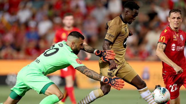 Mohamed Adam of the Wanderers beats Adelaide’s Paul Izzo to score at Coopers Stadium. Picture: AAP