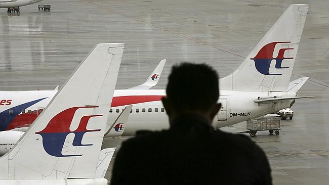 Search for answers...A visitor looks out from the viewing gallery as Malaysia Airlines ai