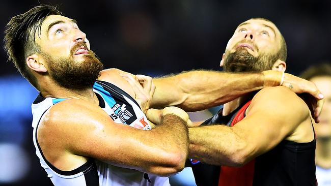 Charlie Dixon of Port Adelaide and Tom Bellchambers of the Bombers battle.