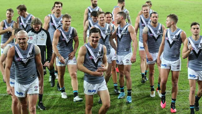 GOLD COAST, AUSTRALIA - JUNE 21: Port Adelaide players celebrate the win during the round 4 AFL match between the Fremantle Dockers and Port Adelaide Power at Metricon Stadium on June 21, 2020 in Gold Coast, Australia. (Photo by Jono Searle/AFL Photos/via Getty Images )