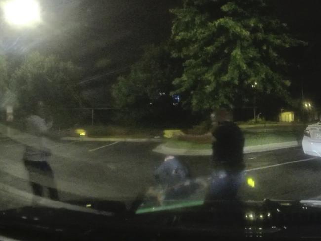 This screen grab taken from dashboard camera video shows Rayshard Brooks, left, and Officer Garrett Rolfe pointing tasers at one another. Picture: Atlanta Police Department/AP