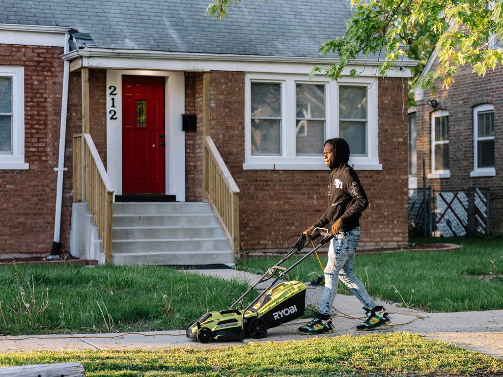 Jaden Davis, next door neighbor to the childhood home of Pope Leo XIV, mows the lawn outside of the Pope's former home in Dolton, Illinois. Picture: Getty