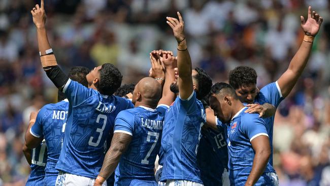 Somoa players gesture ahead of their men's pool B rugby sevens match. Photo by CARL DE SOUZA / AFP.