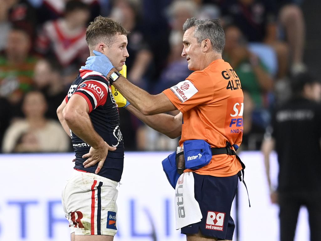 Sam Walker undergoes an on-field test after being hit by Jack Wighton.