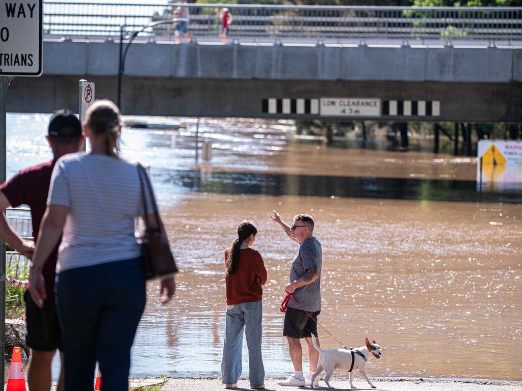 People watch on as the water level approaches the bottom of the Windsor Bridge on Saturday afternoon. Picture: Flavio Brancaleone