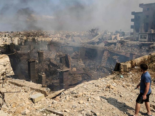 TOPSHOT - A man checks the destruction at a factory targeted in an overnight Israeli airstrike in the town of Chouaifet south of Beirut on September 28, 2024. (Photo by Anwar AMRO / AFP)