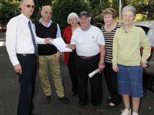 LOVERS OF LITERATURE: Graeme and Janine Wilson, Peter Harris of Lismore Community Action network, Trish Gibson of Friends of the Library and supporter Corena Wynd hand a 904-signature petition to Lismore Council corporate compliance co-ordinator Gianpiero Battista in a bid to save Goonellabah Library. Picture: Doug Eaton