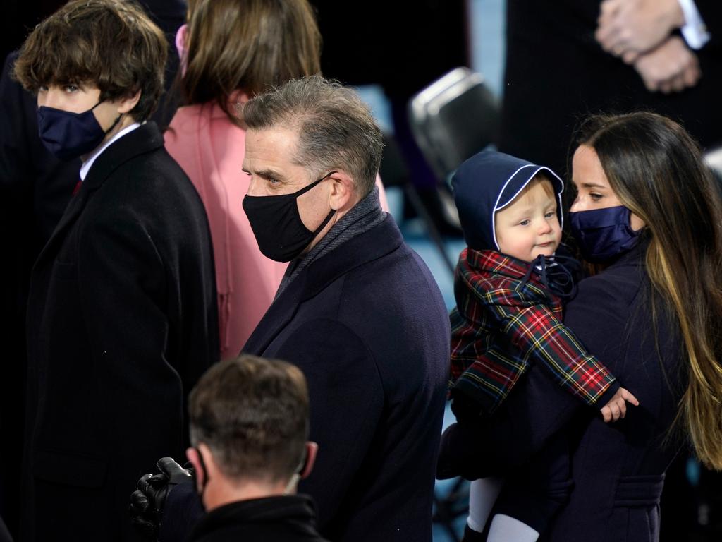 Ashley Biden carries her nephew alongside half-brother Hunter during the inauguration. Picture: Getty Images