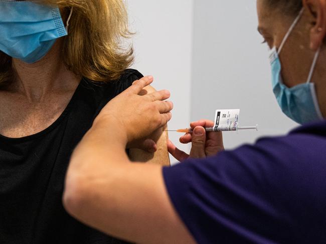 MELBOURNE, AUSTRALIA - MARCH 17: A nurse administers the AstraZeneca COVID-19 vaccine to a patient at the Austin Hospital on March 17, 2021 in Melbourne, Australia.  An online system has opened for phase 1B of the Australian COVID-19 vaccination program which includes people over aged 70, frontline workers, and individuals with certain medical conditions. Over 1000 general practitioners are participating in the vaccination program. (Photo by Asanka Ratnayake/Getty Images)