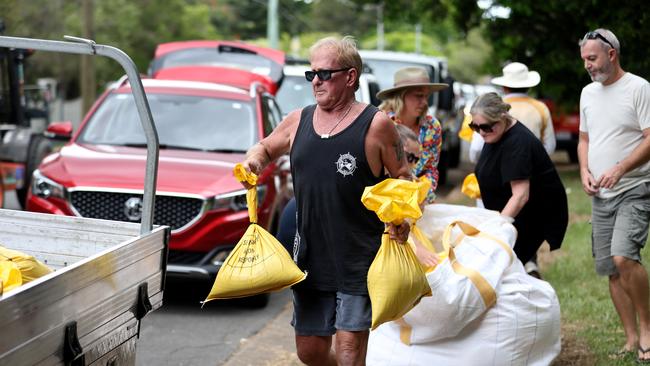 Preparations are underway in the Wynnum for the possible arrival of Tropical Cyclone Alfred, pictured are locals collecting sandbags from the Lota sandbagging location. Picture: David Clark