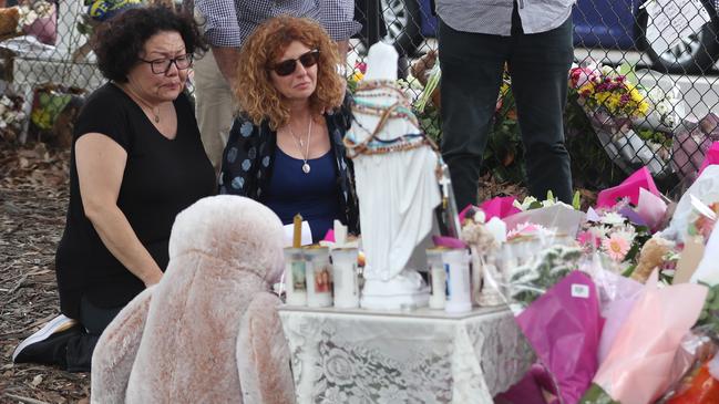 Bridget Sakr, being comforted by friends at a memorial just after the tragedy, has immersed herself in initiatives to help people dealing with grief. Picture John Grainger